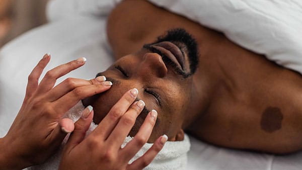 Man receives a rejuvenating facial massage during a signature skincare treatment at The Spa at Gervasi Vineyard in Canton, Ohio.